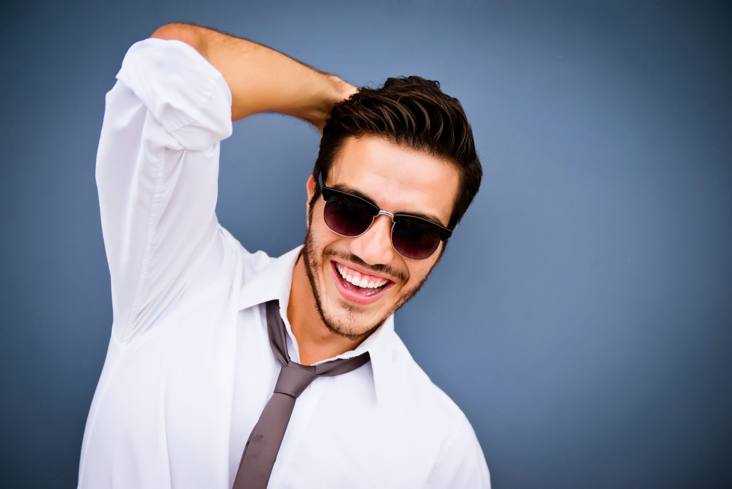 A smiling man looks handsome with his non surgical hair restoration toupee.